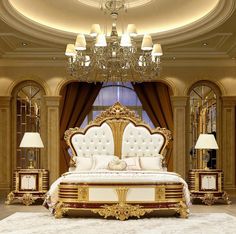 a large bed sitting under a chandelier in a bedroom