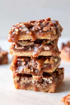 three pieces of chocolate caramel pretzel bars stacked on top of each other