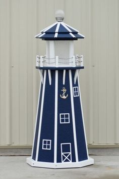 a blue and white lighthouse with an anchor on it