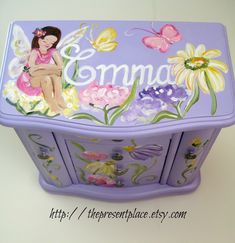 a purple box with flowers and a fairy sitting on it's lid that says momma