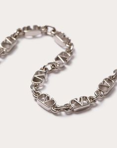 Valentino Garavani metal VLogo Signature bracelet -Palladium colour finish -VLogo dimensions: 0.8 x 0.5 cm / 0.3 x 0.2 in. -Available in sizes: S - 19.5 cm / 7.7 in., M - 20.5 cm / 8.1 in., L - 21.5 cm / 8.5 in. -Snap hook closure -Made in Italy Silver Metal Jewelry With Metal Logo, Silver Metal Jewelry With Logo, Luxury Metal Jewelry With Metal Logo, Luxury Silver Jewelry With Metal Logo, Sterling Silver Jewelry With Silver-tone Logo, Elegant Metal Necklace With Silver-tone Logo, Formal Silver Jewelry With Logo Charm, Designer Silver Jewelry With Logo Charm, Luxury Metal Jewelry With Logo Charm