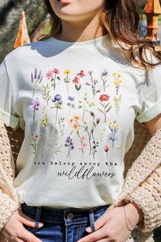 Wildflowers Graphic T Shirts.Unisex Crew Neck Short Sleeve Tees.Crafted from premium materials, tailored to your lifestyle, ensuring a comfortable fit for any occasion.Family Group Uniforms Birthday Party Gift Concert Festival Events.High Quality Direct To Film Printed Graphic Design.100%COTTON,HEATHER(52%COTTON,48%POLY),ATH.HEATHER,BLACK HEATHER(90%COTTON,10%POLY)NICARAGUAMade In: Nicaragua Green Shirt With Text Print For Spring, Spring Crew Neck Shirt With Sublimation Print, White Botanical Crew Neck Top, Green Letter Print Shirt For Spring, Flower T Shirt Design, Spring Graphic Tee With Sublimation Print, Spring Graphic Tee Shirt With Sublimation Print, Spring T-shirt With Text Print, Flower T Shirt