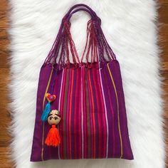 Colorful Striped Hand Woven Bag Comes With A Heart Tassel Charm And A Frida Tassel Charm Color Is Bright Purple. Daily Use Purple Handwoven Shoulder Bag, Rectangular Purple Woven Shoulder Bag, Daily Use Purple Handwoven Bag, Rectangular Purple Handwoven Bag, Bohemian Purple Rectangular Bag, Bright Purple, Woven Bag, Tassel Necklace, Tassels