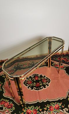 a glass and metal coffee table on a rug