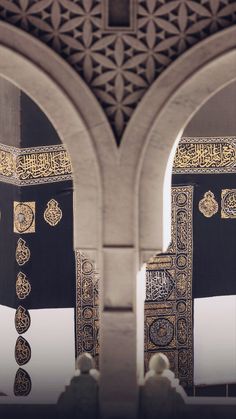 two large black and gold decorations in an archway