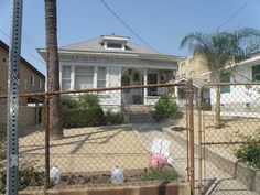 the house is behind a chain link fence