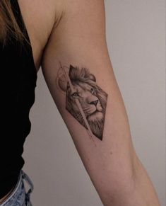 a woman's arm with a lion tattoo on the left side of her arm