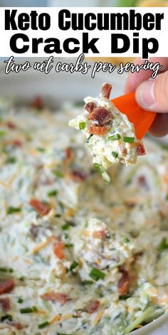 a hand holding a carrot and cucumber dip over a casserole dish