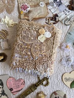 an old lace book surrounded by other antique and vintage buttons, tags, and more