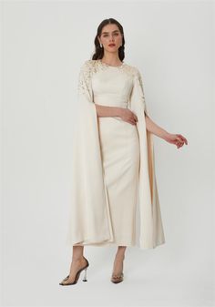 Step into sophistication with this stunning cape sleeve long dress, perfect for making a statement at any special occasion. This dress features a sleek and elegant design, highlighted by exquisite embellishments on the shoulders that add a touch of sparkle and glamour. The flowing cape sleeves create a dramatic yet graceful silhouette, ensuring you stand out in any crowd. Whether you're attending a formal event, wedding, or evening gala, this dress offers timeless elegance with a modern twist. P Elegant Evening Dress With Cape Sleeves For Banquet, Elegant Party Dress With Cape Sleeves, Elegant Party Evening Dress With Cape Sleeves, Gala Evening Dress With Cape Sleeves, Embellished Gown With Cape Sleeves, Elegant Cape Dress For Banquet, Elegant Cape Gown For Wedding, Formal Evening Dress With Cape Sleeves, Embellished Evening Dress With Cape Sleeves For Gala