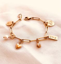 Customize your own Stories Charm bracelet! Explore our wide selection of beautiful charms to effortlessly create a unique personalized and stylish accessory. You can wear it daily, whether swimming or bathing, 24/7, without any worries. If you order the tag and birthstone, please leave a message. For example: C (heart) J and birthstones for May and July. Our charms options:1. Tag - Tag: Stamp 4 Characters Max.2. Heart Drop - 14k gold filled3. Cross - 14k gold filled.4. Pearl Drop- 14k gold fille Everyday Bracelets With Dangling Charms, Gold Metal Bracelets With Removable Charms, Everyday Bracelets With Removable Charms, Yellow Gold Bracelet With Dangling Charms For Gifts, Elegant Everyday Bracelets With Dangling Charms, 14k Gold Charm Bracelet With Dangling Charms As Gift, Gold Dangle Bracelets With Charms, Everyday Gold Bracelets With Dangling Charms, Everyday Gold Bracelet With Charms