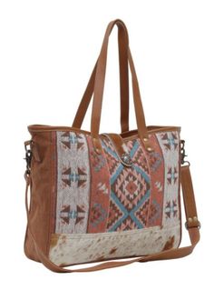 Crafted for the modern adventurer, this exquisite tote bag combines the timeless appeal of a beautiful Southwest printed canvas with the durability and sophistication of leather and hide accents. Featuring double shoulder straps for easy carrying and an adjustable crossbody strap for hands-free convenience, this tote offers versatility and comfort in any situation. The full zip and magnetic flap closure ensure your belongings are secure yet easily accessible, providing peace of mind whether you' Canvas Satchel Shoulder Bag With Adjustable Strap, Canvas Shoulder Bag With Adjustable Strap, Weekend Shoulder Satchel Bag With Removable Pouch, Weekend Trip Satchel Shoulder Bag With Removable Pouch, Casual Satchel With Adjustable Strap For Weekend Trips, Canvas Hobo Bag With Adjustable Strap, Canvas Satchel Shoulder Bag For Travel, Large Canvas Shoulder Bag For Travel, Weekender Shoulder Bag With Adjustable Handle