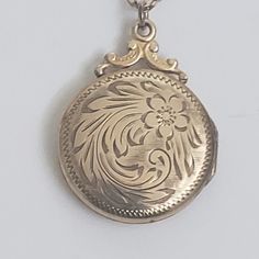 "Mid century round gold fill locket and chain with etched floral design. Personalized message on back, \"Peter and Jack Xmas '53. Locket closes with snap, Both the locket and chain are marked Gold filled 8. The locket is 1 3/8\" by 1\". The necklace length is 18\".  Previously owned and in good condition. There are minor signs of age/use. The pictures are part of the description.  Do browse our other items. We combine shipping for savings. International purchasers may wish to contact the shop for an accurate quote to the shipping address." Antique Medallion Necklace With Locket, Vintage Charm Medallion Necklace Gift, Antique Keepsake Locket Necklace With Hallmark, Vintage Medallion Locket Necklace As Gift, Gift Medallion Necklace With Vintage Charm, Keepsake Medallion Locket Necklace With Hallmark, Round Medallion Necklace With Vintage Charm As A Gift, Antique Medallion Locket Necklace, Vintage Etched Locket Necklace For Anniversary