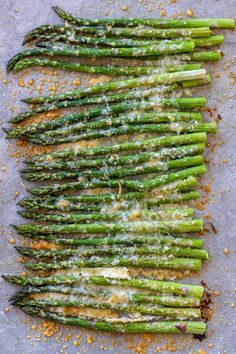 cooked asparagus with parmesan cheese and seasoning sprinkled on top