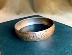 "Vintage Brass Hand Engraved Wide Bangle Bracelet. This floral design bracelet is in very good vintage condition except some minor tarnish stains. Please see the attached photos for details. Dimensions: 2.65\"Diameter x 0.50\" W Thank you for checking out our shop! Kindly keep in mind that all of the items we sell are vintage or antique, and as such may have signs of wear in keeping with age and use. We will try our best to indicate any damage and to show the detail in the attached photographs." Brass Candle Holders, Brass Candle, Vintage Art Prints, Candle Set, 1950s Vintage, Tea Bag, Hand Engraving, Bracelet Designs, Vintage Brass