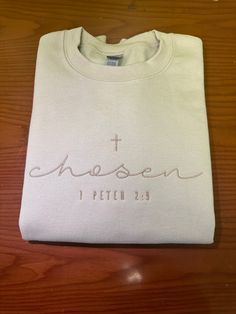 Embroidered Chosen Sweatshirt, Bible Verse Peter Shirt, Christian Crewneck, Embroidered Christian Hoodie, Gifts For Christians E016 COLOR AND SYTLE :  Sweatshirt Color: Sand Thread Color : Tusk  Our custom shirts are the perfect gift for your loved ones, guaranteeing their admiration for years to come. At Custom PANDA shirts, we pride ourselves on providing unparalleled customer service, post-sale support, and top-quality products. Our dedicated team meticulously crafts each shirt to order, ensuring your satisfaction from the moment you place your order to its delivery. Our shirts feature premium materials, setting industry standards. We collaborate with leading apparel companies to ensure you receive the finest products on the market. We promise you won't regret choosing us. Thank you for Embroidered Bible Verse Shirt, Christian Crewneck Sweatshirt, Christian Embroidered Sweatshirt, Chosen Sweatshirt, Gifts For Christians, Christian Outfits, Christian Embroidery, Christian Clothes, Christian Products