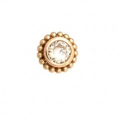 a gold plated ring with a crystal stone in the center and beading around it