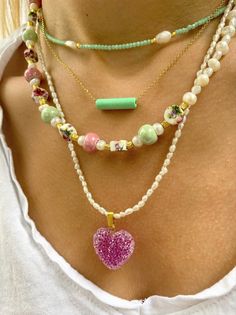 Four different handmade summer necklaces with different beads and charms but similar philosophy. The first necklace has some tiny beads in lyght green color, the second one is a dainty necklace with a light green bar from ceramic that is passsed through a gold chain, the third one is a really special neckalce with colorful ceramic beads and pearls. The last necklace is a pearls beaded necklace Combine them all together or wear them separetely as well. In Christina Christi Jewels store you can se Beach Green Jewelry With Heart Beads, Green Heart-shaped Beaded Necklace Gift, Green Heart Beads Jewelry For Beach, Handmade Green Beads For Everyday, Green Necklaces With Pearl Charm And Round Beads, Green Heart Beads For Beach, Handmade Charm Necklaces With Round Beads For Everyday, Green Heart-shaped Beaded Necklaces, Handmade Everyday Charm Necklaces With Round Beads