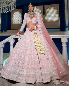 Reverie Bridal set is a stunning coral pink lehenga hand embroidered on pure raw silk fabric with signature glass crystals, pearls, sequins, and beads and has scalloped edges on the lehenga. It's paired with an attractive hand-embroidered blouse with cap sleeves on net fabric. It comes with a peachy pink soft net scall Pink Hand Embellished Lehenga For Festivals, Traditional Pink Hand Embellished Choli, Pink Hand Embellished Anarkali Set For Wedding, Hand Embellished Pink Anarkali Set For Wedding, Pastel Lehenga, Latest Bridal Lehenga, Raw Silk Lehenga, Lehenga Designs Simple, Raw Silk Fabric