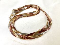 "Vintage 80s braided tricolore triple chevron flat snake chain necklace with the sensuous shiny polished looks of the pale gold, silver and copper (dark rose gold) and the decorative texture and understated elegance. The necklace is 1 cm (0.4\") wide,44 cm (17.3\") long  including the spring ring clasp,weighs 40 gr and in excellent vintage condition. For more vintage jewellery please visit my Etsy shop: http://vintageviomar.etsy.com SHIPPING  UK -Royal Mail 1st Class (delivery aim 1- 2 days)  Everywhere Else - Royal Mail International Tracked and Signed  (delivery aim 10-14 days) INTERNATIONAL BUYERS-PLEASE NOTE: Import duties,taxes and charges are not included in the item price or shipping cost.These charges are buyers responsibility.Please check with your country's custom office to deter Snake Chain Necklace Gold, Decorative Texture, Chain Necklace Gold, Snake Chain Necklace, Dark Rose, Statement Choker Necklace, Custom Office, Pale Gold, Understated Elegance