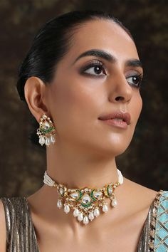 22k gold-plated choker with kundan encrusted pendant, multi- pearl strings and crescent moon motifs. Comes with danglers.
ComponentsNecklace, Pair of earrings
Type:Kundan, Stone, Pearl
Composition:Silver Alloy
Color:Gold
Multi-pearl strings
Pearl drops
Weight (gms): 110
Size (inch): Necklace: 14; Earrings: 1.75
Closure: Necklace: Adjustable drawchord; Earrings: Push back clasp - Aza Fashions Diamond Tufted Headboard, Choker Jewellery, Pendant Choker Necklace, Pendant Choker, Choker Necklace Set, Bead Pendant, Jewelry Choker, Jewellery Set, 22k Gold