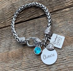 "Create a custom bracelet with your special words for all those special gals in your life. This bracelet features an antique silver plated bracelet that is lead~free, nickel~free, cadmium~free, that has a 7.75\" long chain and 25mm x 16mm large lobster clasp. Dangling from the bracelet will be * birthstone charm - color of choice from secondary sample photos * 20mm stainless steel circle charm laser engraved with a name or short message (25 characters) * antique silver filigree rhinestone heart Silver Charm Bracelet For Anniversary, Classic Silver Name Bracelet For Birthday, Hypoallergenic Name Bracelet For Anniversary, Silver Name Bracelet Jubilee Style For Birthday Gift, Silver Charm Bracelet With Birthstone For Anniversary, Silver Hand Stamped Charm Bracelet For Anniversary, Silver Hand Stamped Name Bracelet For Anniversary, Personalized Vintage Charm Bracelet Gift, Silver Nickel-free Name Bracelet For Birthday