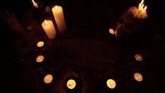 many lit candles are arranged in the shape of a heart