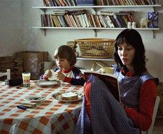 two people sitting at a table with food