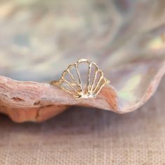 Introducing the Spirit of the Sea Ring, a delicate treasure fit for a mermaid. Immerse yourself in its golden glow, evoking moonlit shores and hidden realms beneath the waves. Handcrafted in solid 14k gold, this ring is more than just an accessory—it’s a reminder of the untamed beauty and limitless possibilities that reside within you. With each wear, feel the echoes of ancient sea tales and the call of the tides. The Spirit of the Sea Ring captures the essence of coastal magic, making it the pe Gold Shell Ring, Handmade Gold Shell Jewelry, Gold Beach Jewelry, Gold Snake Jewelry, Sea Ring, Sea Rings, Seashell Ring, Ocean Ring, Fantasy Earrings