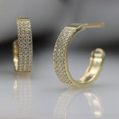 Brilliant luxurious moissanite pavé-set in 14k yellow gold This open hoop is easy to wear and will sparkle from every angleFull of Sparkle just like a diamond at a great price.- In a pair there are 116 Moissanite 1 mm pavé-set, VVS-E, total carat 0.58Handmade by an inspired jewelry artist team with decades of experience in the craft of jewelry making.Each gemstone, each diamond is carefully picked.Using only the finest raw materials and the highest industry standard in manufacturing, design and Green Stone Rings, Open Hoop Earrings, Moissanite Earrings, Vermeil Jewelry, Diamond Hoop Earrings, 925 Sterling Silver Earrings, Blue Earrings, Engagement Rings Sapphire, Artistic Jewelry