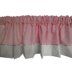 pink and white ruffled valance with red trim on the bottom, hanging from a rod