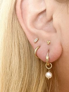 The perfect everyday earrings- now with genuine freshwater pearls! Our lightweight huggie hoop earrings measure about 12mm and are so comfortable, you'll never want to take them off! These simple beauties will never tarnish and can live life with you! 14k gold-filled hoops (pair) 6-7mm freshwater pearls Nickel Free, Hypoallergenic, and Lightweight Measures 12mm and made to gently hug your ear Signature Gift Packaging Included 14k Gold-filled Huggie Hoop Earrings With Pearl Charm, Everyday Pearl Charm Huggie Jewelry, Everyday Huggie Jewelry With Pearl Charm, Everyday Gold Huggie Pearl Earrings, Everyday 14k Gold Hoop Earrings With Pearl Charm, Everyday Pearl Charm Huggie Earrings, Everyday Hoop Earrings With Pearl Charm, 14k Gold Pearl Charm Huggie Earrings, 14k Gold Huggie Earrings With Pearl Charm