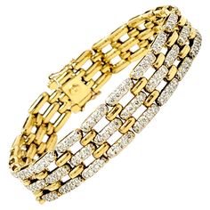 Gorgeous glittering diamond bracelet looks elegant and sophisticated on the wrist. This 1/2" wide solid 18 karat yellow gold bracelet sparkles and shines with 260 round diamonds prong set into attractive, elongated links. There are approximately 5.50 carats total in this incredible piece. The diamonds are H in color, VS in clarity and really pop against the yellow gold. It has a locking push clasp and two additional safety clasps. This bracelet is an estate piece that has been professionally cle Yellow Gold Bracelet, Link Bracelets, Prong Setting, Panther, Types Of Metal, Diamond Bracelet, Round Diamonds, Metallica, Jewelry Box