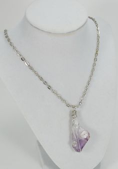 Each Amethyst necklace is carefully hand wrapped with silver plated copper wire and is suspended from a stainless chain. Pendant measures approximately 1 1/2 inches in length. Each stone is cleansed, charged and blessed before shipping to maximize it fullest potential. NOTE: Item pictured is NOT the exact Item you will receive. All items in stock bear a close resemblance to the item pictured, but because these are natural stones, the size, shape and color will slightly vary for the item purchase Silver Teardrop Pendant Necklace Hand Wrapped, Hand Wrapped Silver Plated Pendant Necklace, Silver Plated Wire Wrapped Necklaces, Gift Necklace With Gemstone On Silver Plated Wire, Silver Wire Wrapped Crystal Necklaces For Jewelry Making, Silver Plated Wire Necklaces With Gemstone For Gift, Hand Wrapped Pendant Necklace In Silver Plated Wire, Silver Hand Wrapped Metal Necklace, Gift Silver Plated Gemstone Necklace