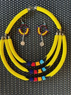 "Lovely colorful African handmade draping jewelry necklace and earring set. This is a bright and colorful ceremonial necklace with matching earrings, handmade on the Masai Mara in Kenya, Africa. It is a bright yellow which drapes across the chest. There is just something about Africa that seeps into your soul and stays with you. I set out to paint Utah and all of its beauty...but my heart keeps returning to Africa again and again. If you are looking for a unique cultural piece of Africa or one-of-a-kind gift for someone who loves Africa, this beautiful colorful jewelry set will make a wonderful gift.   If desired, please utilize the zoom feature to study image details. Due to monitor calibrations, colors may vary slightly from the original and your screen image. Please read complete detail Draping Jewelry, Maasai Beads Necklace, Maasai Bracelet Kenya, Traditional Yellow Hand-strung Beaded Necklaces, Africa Shaped Earrings, Masai Necklace, Humanitarian Work, Masai Mara, Jewelry Beaded