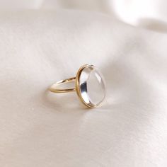 This stunning ring is set in 14k Solid Yellow Gold with Natural Clear Quartz with utmost precision. It is an unique statement gemstone ring for nearly every occasion and is completely hassle-free jewelry. 🔷ABOUT GEMSTONE: Clear quartz, often referred to as the "Master Healer," is a pristine, transparent variety of quartz renowned for its pure energy and versatility. Its crystal clarity represents clarity of mind, and it is believed to amplify the properties of other gemstones. It serves as a po Luxury Oval Jewelry With Si Clarity, Elegant Moonstone Ring As Gift, Modern Oval Rings With Vs Clarity, Yellow Gold Dome Ring With Gemstone For Gift, Modern Oval Jewelry With Vs Clarity, Modern White Gold Crystal Ring For Gift, Classic Oval Rings With Si Clarity, Elegant Gold Crystal Ring With Cabochon, Timeless White Gold Crystal Ring Gift