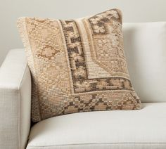 a white couch with a decorative pillow on it