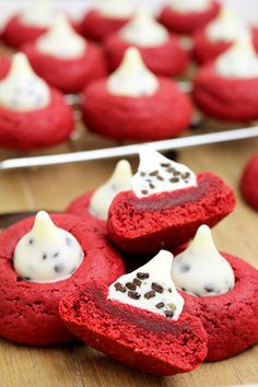 red velvet cookies with white frosting and chocolate chips in the shape of heart shapes