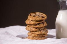 a stack of cookies next to a glass of milk