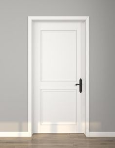 an empty room with a white door and wooden floor