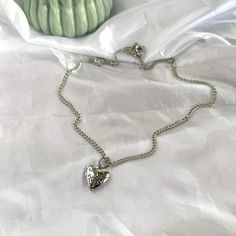 these heart locket necklaces are simple enough to be layered with your other pieces of jewelry✨  -silver plated, nickel free chain and charm -lightweight design -small heart locket, about the size of a penny! -simple, minimal, dainty necklace -necklace length: 18 inches long/extender included Everyday Metal Charm Necklace With Heart Pendant, Everyday Metal Heart Pendant Charm Necklace, Valentine's Day Silver Charm Necklace With Chain, Valentine's Day Silver Charm Necklace, Heart Charm Necklace With Round Pendant, Silver Charm Necklace For Valentine's Day, Heart Charm Metal Necklace, Silver Double Heart Necklace With Chain, Trendy Silver Charm Necklace For Valentine's Day