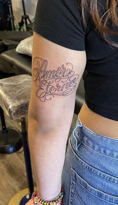 a woman with a tattoo on her arm that says, amazing stories in cursive writing