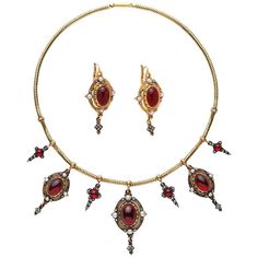 A prime example of Holbeinesque Jewelry, this incredible piece of history features matching necklace and earrings highlighting over 32 carats of phenomenal cabochon garnets set amidst 100 Rose Cut Diamonds and accent pearls. The total weight of this impressive 14kt yellow gold antique necklace and earrings set is 49.7g. Displayed in the original box from the Mid 1800's, this is a set that is sure to turn heads whether worn during an elegant evening out or displayed as part of a collection. Pearl Diamond Necklace, Antique Jewelry Victorian, Mood Jewelry, Pearl And Diamond Necklace, Oc Inspo, Garnet Pendant, Garnet Jewelry, Antique Necklace, Fabulous Jewelry