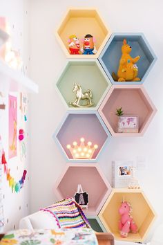 a bedroom with hexagonal shelves filled with toys