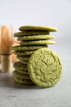 green cookies stacked on top of each other with a toothbrush in the back ground