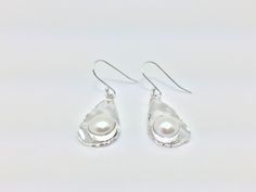 Hi everyone, just wanted to let you know we are open and shipping daily. Beautifully crafted handmade pearl and sterling silver dangle earrings. Features perfectly matched hand picked South Sea Pearls in a stunning silver setting so unique you will not go unnoticed. This line of pearl jewelry makes excellent brides made gifts and has been a top seller in our San Francisco jewelry store for years.