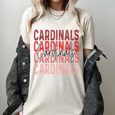 a woman wearing a white t - shirt that says cardinals cardinals