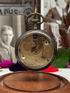 This is a 1920s/30s pocket watch in working order. The back has an interesting reef engraving. Changing time is very unconventional - a button must be held down (close to the winder) and then changed. Notably the face of the watch is missing but oddly everything else is in great condition. the crystal is glass and has no flaws. There's a decent bit of wear around the silver metal however. I believe this is what is referred to as a dollar watch - typically cheaper watches that would work for a shorter time or aren't as reliable as higher grade ones. The absence of a serial number and manufacturer indicate it's a cheaper watch as well. The watch does tick but there cannot be any gaurentee that it keeps good time since the hands and face are missing.  NO RETURNS ACCEPTED - Message me with any Silver Pocket Watch, Cheap Watches, Engraving Art, Pocket Watches, Ticks, Olympia, Pocket Watch, Time Piece, Metallic Silver