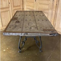 an old wooden table with metal legs