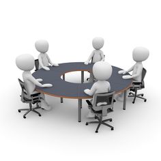 five people sitting around a round table with one person talking to the other on it